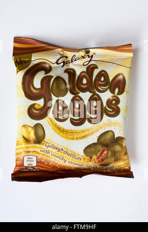 Bag of new Galaxy golden eggs Galaxy chocolate with crunchy caramel rolled in gold isolated on white background - ready for Easter Stock Photo