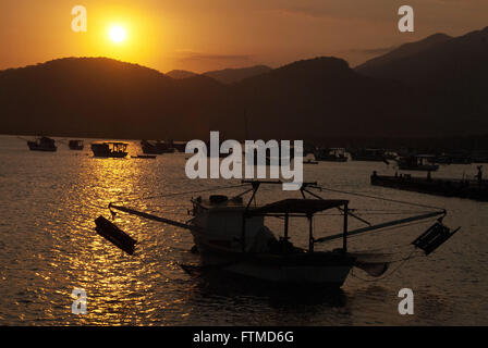 Sunset Bertioga Channel with fishing boats moored Stock Photo