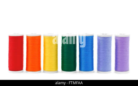A row of sewing thread spools isolated on white Stock Photo - Alamy