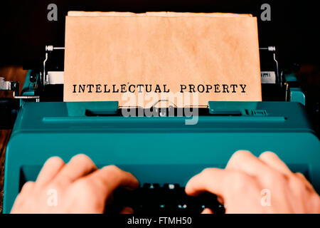 the text intellectual property written in a yellowish paper with a retro typewriter Stock Photo