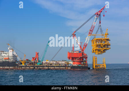 Oil rig lifting for installation on its jacket Stock Photo