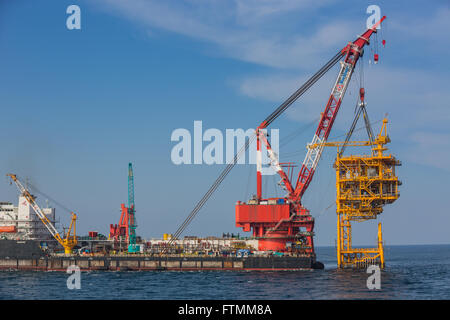 Oil rig lifting for installation on its jacket Stock Photo