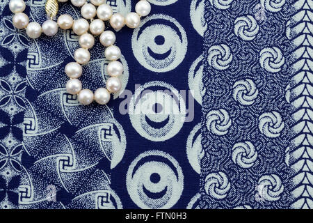Pearl necklace on blue and white African pattern cloth