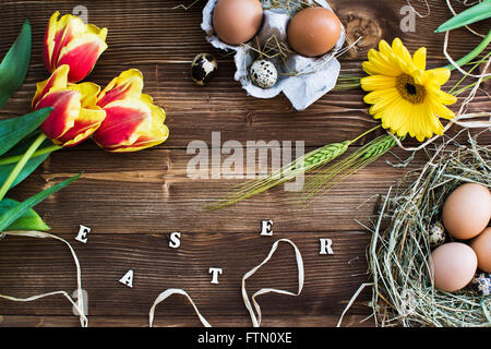 Colorful tulips with eggs on wooden. Happy easter. Spring time. Stock Photo