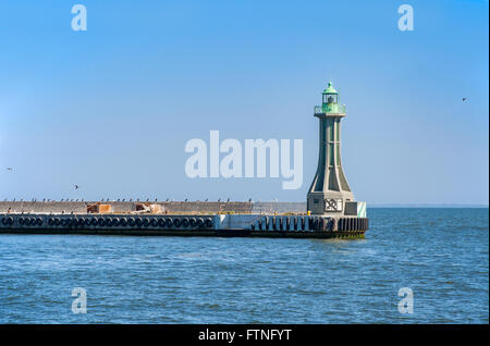 Small lighthouse - harbor entrance light on the groin in Gdynia, Poland Stock Photo