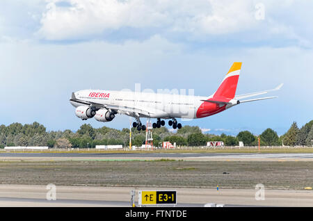Aircraft -Airbus A340-, of -Iberia- airline, is landing in Madrid Barajas airport (Spain). Photo set: 2 of 2. Stock Photo