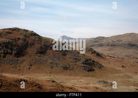 The distant Langdale Pikes viewed from  near Dow Bank above Grasmere Lake District Cumbria England Stock Photo