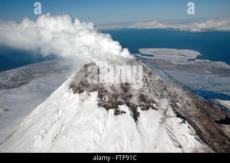 A steam plume rises from the snow-covered lava dome at the summit of Augustine Volcano on Augustine Island in the lower Cook Inlet April 6, 2006 in Alaska. The volcano consists of a central dome and lava flow complex, surrounded by pyroclastic debris. Stock Photo