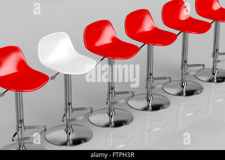 One unique white bar stool in a row of red bar stools Stock Photo