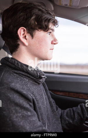 Teenage boy learning to drive on interstate highway. Stock Photo