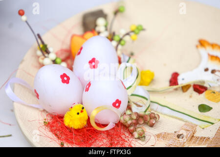 ZAGREB, CROATIA - MARCH 26, 2016 : Three artificial easter eggs on a painted plate in Zagreb, Croatia. Stock Photo