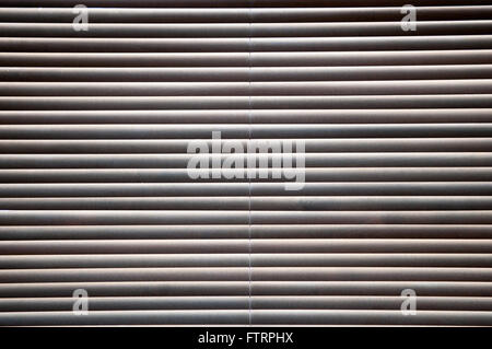 Morning sun shining through closed wooden blinds Stock Photo