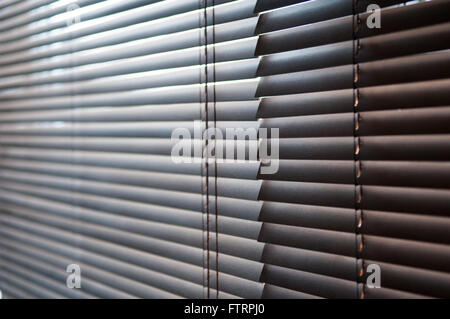 Morning sun shining through closed wooden blinds Stock Photo
