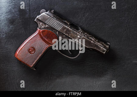 semi-automatic pistol on black leather Stock Photo