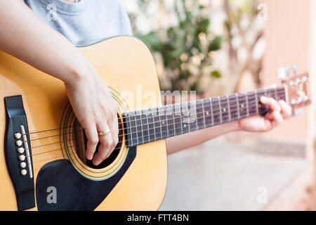 Woman's hands playing acoustic guitar, stock photo Stock Photo