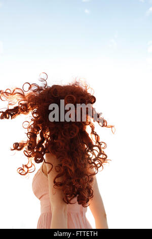 Curly redhead woman turning