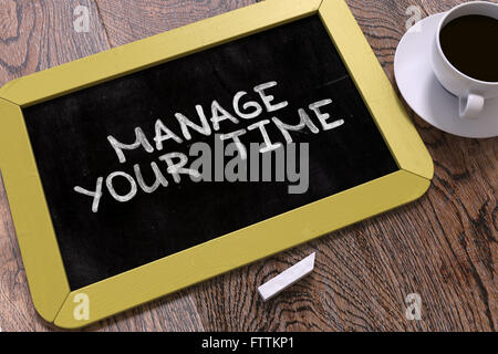 Manage Your Time Handwritten by white Chalk on a Blackboard. Stock Photo