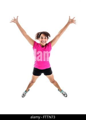 Photograph of young mixed race female in bright workout wear jumping for joy. Stock Photo