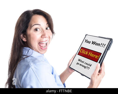 A young woman is overjoyed by message on her tablet computer stating she has won a prize, not realizing it is a scam. Stock Photo