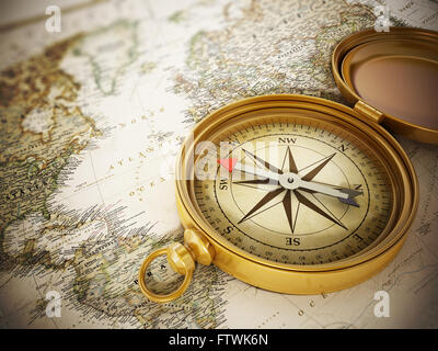 Vintage compass standing on old world map Stock Photo