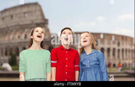 amazed children looking up over coliseum in rome Stock Photo