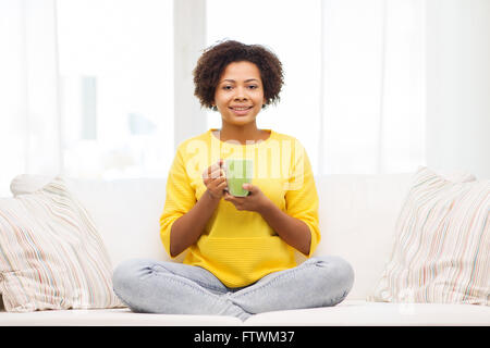 happy african american woman drinking from tea cup Stock Photo