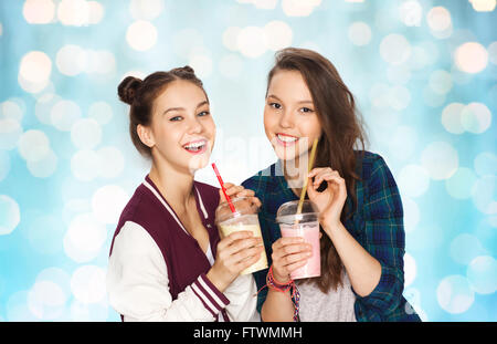 happy pretty teenage girls drinking milk shakes Stock Photo