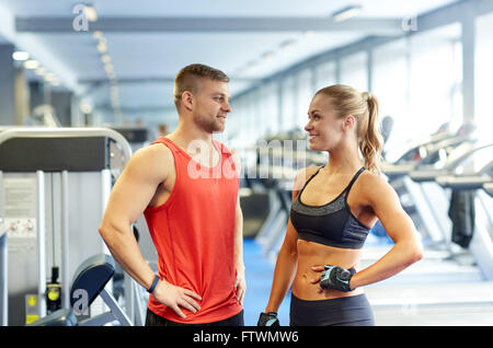 smiling man and woman talking in gym Stock Photo