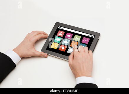 close up of man hands with app icons on tablet pc Stock Photo