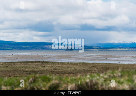 View of oil rig and mountains in background at Nigg Stock Photo