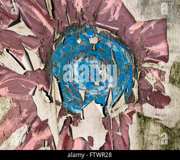 An old abandoned, peeling paint mural depicting a flower. Stock Photo