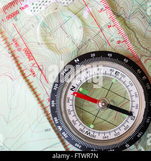 Compass on Map. A compass placed on a map. Stock Photo