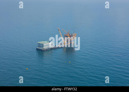 Aerial shot of oil rig and barge during installation phase Stock Photo