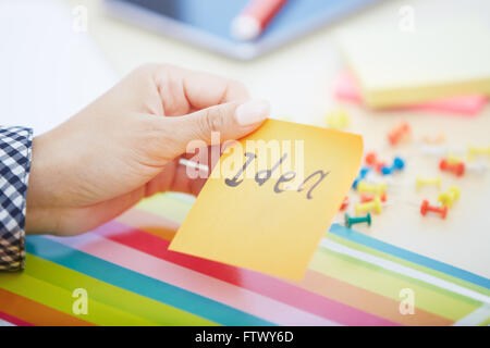 Human hand holding adhesive note with Idea text Stock Photo