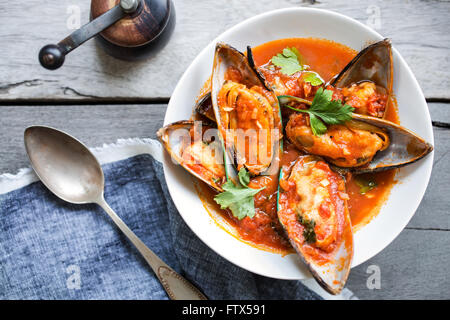 New zealand Mussels in Tomato and herbs sauce Stock Photo