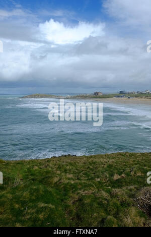 Upright view looking east across Fistral Bay, Newquay, Cornwall with blue sky and fluffy clouds Stock Photo