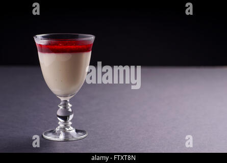 Raspberry and Strawberry cheesecake served as dessert in a glass, isolated on Black background Stock Photo