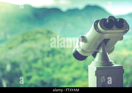 Vintage toned photo of landscape binoculars overlooking mountains Stock Photo