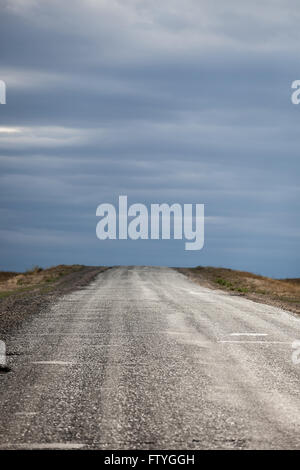 Kazakhistan, Kazakistan,Asia, a dirty road in direction of the cloudy sky. Stock Photo