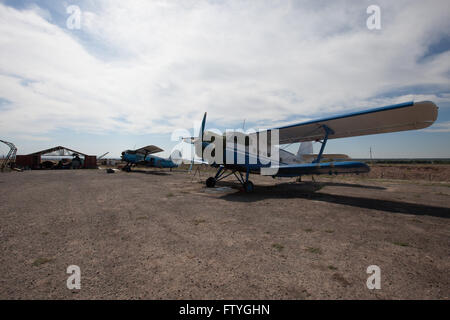 Kazakhstan, Kazakistan, Asia, landed agriculture airplanes near to the hangar. Stock Photo