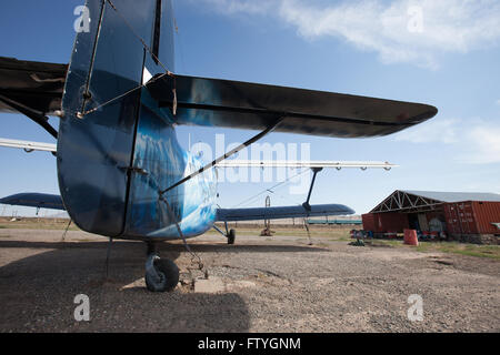 Kazakhstan, Kazakistan, Asia, landed agriculture airplane, biplane near to the hangar. Stock Photo