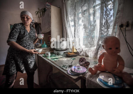 Kirghistan, Kirghizistan, ,a woman in kitchen making tea. Stock Photo