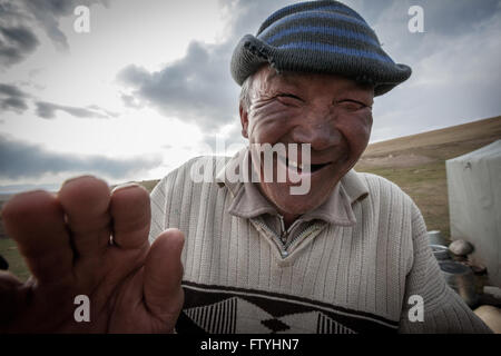 Kyrgyzstan, Kirghizistan, Asia, a smiling old man, shepherd in the steppe. Stock Photo