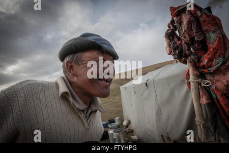 Kyrgyzstan, Kirghizistan, Asia, a smiling old man, shepherd in the steppe. Stock Photo