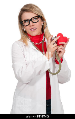 Beautiful young woman cardiologist doctor holding a heart Stock Photo