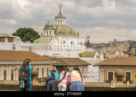 QUITO, ECUADOR, OCTOBER - 2015 - Group of teens watching from San Francisco church the cityscape view and metropolitan cathedral Stock Photo