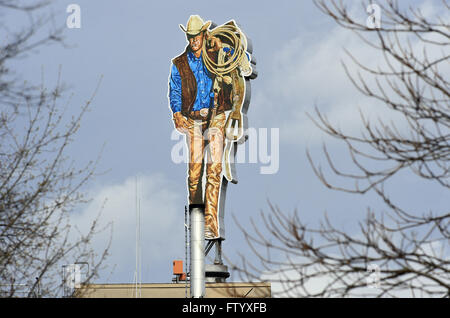 Berlin, Germany. 30th Mar, 2016. A Marlboro Man figure pictured on the rooftop of the cigarette manufacturer 'Philip Morris' in Berlin, Germany, 30 March 2016. Photo: SOEREN STACHE/dpa/Alamy Live News Stock Photo