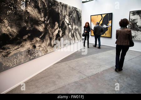 Paris, France. 30th Mar, 2016. Visitors look at paintings during a preview of the Paris Art Fair, at the Grand Palais in Paris, France, March 30, 2016. The Paris Art Fair 2016 will open from March 31st to April 3rd, with the participantion of over 150 art galleries from all over the world. © Theo Duval/Xinhua/Alamy Live News Stock Photo