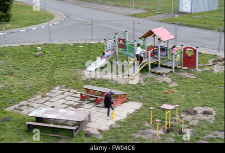 Bad Fallingbostel, Germany. 30th Mar, 2016. Refugee children play on a playground at the site of the Camp Bad Fallingbostel Ost refugee accommodation in Bad Fallingbostel, Germany, 30 March 2016. Around 850 are currently being housed in Camp Ost. Photo: HOLGER HOLLEMANN/dpa/Alamy Live News Stock Photo