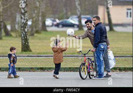 Bad Fallingbostel, Germany. 30th Mar, 2016. Refugees play at the site of the Camp Bad Fallingbostel Ost refugee accommodation in Bad Fallingbostel, Germany, 30 March 2016. Around 850 are currently being housed in Camp Ost. Photo: HOLGER HOLLEMANN/dpa/Alamy Live News Stock Photo